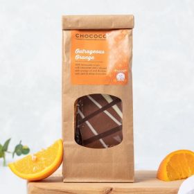 Milk Chocolate Outrageous Orange Slabs by Chococo on chopping board with Fresh Orange wedges and linen napkin 
