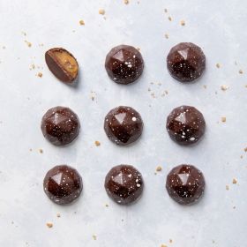 A close up of 16 Dorset Sea Salted Caramel chocolates in a box 