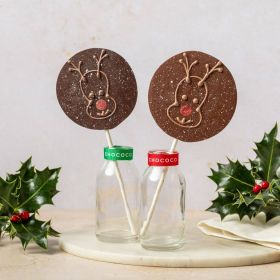 dark chocolate reindeer lolly by Chococo in small glass milk bottle with real holly and berry s around it 