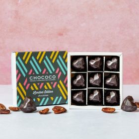 A small box of heart-shaped chococo handcrafted chocolates with maple and pecans 