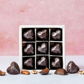 A small box of heart-shaped chococo handcrafted chocolates with maple and pecans 