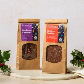 A bag of christmas pudding slabs in milk chocolate in a brown kraft bag  by chococo with real holly as a decoration 