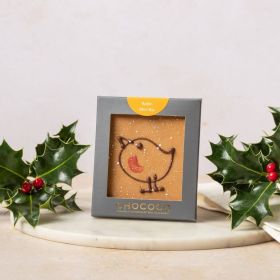 gold chocolate mini bar by Chococo with hand-piped robin design on. Packaged in a grey box sat next to fresh real holly with red berries on 