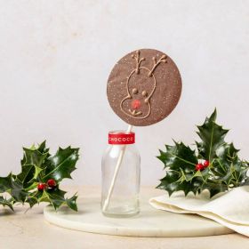 hand piped milk chocolate lolly by Chococo with reindeer face. titled in a small glass milk jar surround with real holly and linen napkin 