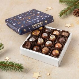 a box of 16 handcrafted luxury festive Christmas chocolates in their box with Xmas trees and pine cones around it 
