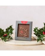 milk chocolate mini bar by chococo with hand piped Christmas robin decoration, in grey packaging surround by real holly with red berries  