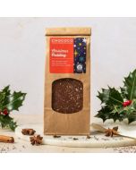 A bag of christmas pudding slabs in milk chocolate in a brown kraft bag  by chococo with real holly as a decoration 