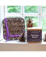 a personliased dark chocolate message bar by chococo on the window sill with Christmas baubles and fern cones 