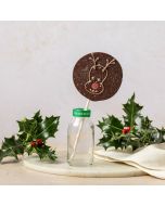 dark chocolate reindeer lolly by Chococo in small glass milk bottle with real holly and berry s around it 