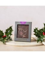 Dark chocolate mini bar by Chococo with hand-piped robin design on. Packaged in a grey box sat next to fresh real holly with red berries on 