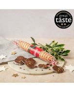 Dark chocolate salami by Chococo on marble charcuterie board with holly, stars & linen napkin 